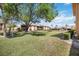 Expansive grassy area with mature trees leading up to the patio of the building at 2347 Beneva Ter # 2251, Sarasota, FL 34232