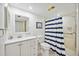 Bathroom featuring a white vanity and a shower with blue and white striped curtain at 2347 Beneva Ter # 2251, Sarasota, FL 34232