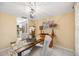 A view of the dining room with a wooden table, upholstered chairs, and floral decor at 2347 Beneva Ter # 2251, Sarasota, FL 34232