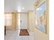 Foyer with white door, white tile flooring, and Impressionism art at 2347 Beneva Ter # 2251, Sarasota, FL 34232