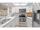 Bright kitchen featuring stainless steel appliances, sleek countertops, and modern backsplash at 2347 Beneva Ter # 2251, Sarasota, FL 34232