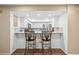 Eat-in kitchen with stainless steel appliances, white cabinets, and tile backsplash at 2347 Beneva Ter # 2251, Sarasota, FL 34232