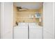 Cozy laundry room features a white washer and dryer with white shelving for storage at 2347 Beneva Ter # 2251, Sarasota, FL 34232