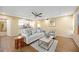 Bright living room featuring wood floors, tray ceiling with ceiling fan, and an open floor plan at 2347 Beneva Ter # 2251, Sarasota, FL 34232