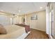 Main bedroom boasts generous closet space, wood-look flooring, and access to a screened patio at 2347 Beneva Ter # 2251, Sarasota, FL 34232