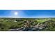 Panoramic aerial shot showcasing the lush community, golf course, surrounding greenery, and distant water views at 236 Saint James Park, Osprey, FL 34229