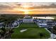 Breathtaking aerial view of a grand estate, showcasing its expansive grounds, lush greenery, and stunning waterfront location at sunset at 236 Saint James Park, Osprey, FL 34229