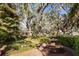 Picturesque backyard garden featuring a tranquil fountain and well-maintained landscaping at 236 Saint James Park, Osprey, FL 34229