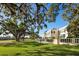 Expansive lawn with mature trees offering scenic views of the estate's manicured grounds at 236 Saint James Park, Osprey, FL 34229