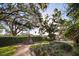 Beautiful garden with a brick pathway, manicured hedges, and a serene water fountain at 236 Saint James Park, Osprey, FL 34229