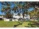 Spacious backyard featuring lush green grass, mature trees, and a charming gated fence at 236 Saint James Park, Osprey, FL 34229