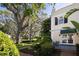 Charming outdoor patio with lush garden views, featuring a path and an inviting sitting area at 236 Saint James Park, Osprey, FL 34229
