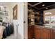 Home wet bar area, including beautiful shelving, cabinetry, and countertop space at 236 Saint James Park, Osprey, FL 34229