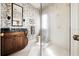 Bathroom vanity with dark wood cabinets, decorative wallpaper, and marble countertop at 236 Saint James Park, Osprey, FL 34229