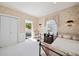 Charming bedroom with floral wallpaper, ornate chair, and access to outdoor balcony at 236 Saint James Park, Osprey, FL 34229