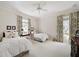 Bright bedroom with two twin beds, patterned curtains, and neutral carpeting at 236 Saint James Park, Osprey, FL 34229