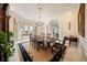 Elegant dining room with a chandelier, large table, decorative rug, and plenty of natural light at 236 Saint James Park, Osprey, FL 34229