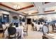 Elegant dining room featuring tables with white linens, chairs, mural, and wood accents at 236 Saint James Park, Osprey, FL 34229