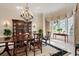 Elegant dining room with seating for six, striped wall paper, bay window, and china cabinet at 236 Saint James Park, Osprey, FL 34229