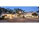 Stately home with lush landscaping, circular drive, and elegant architectural details at twilight at 236 Saint James Park, Osprey, FL 34229