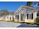 Elegant home exterior featuring a stone driveway and meticulous landscaping, with architectural window and black shutters at 236 Saint James Park, Osprey, FL 34229