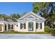 Charming exterior view showcasing a guest house with decorative shutters and manicured greenery at 236 Saint James Park, Osprey, FL 34229