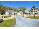 Elegant estate featuring a long driveway, manicured lawns, and a well-maintained front exterior at 236 Saint James Park, Osprey, FL 34229