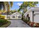 Charming home featuring mature landscaping, a circular drive, and classic architectural details at 236 Saint James Park, Osprey, FL 34229