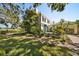 Beautiful home exterior featuring manicured landscaping, a brick walkway, and a tranquil setting at 236 Saint James Park, Osprey, FL 34229