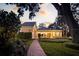 Exterior view of a charming home featuring a brick walkway and manicured garden at 236 Saint James Park, Osprey, FL 34229