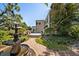 Scenic shot of a tranquil backyard featuring a fountain, lush landscaping, and a patio at 236 Saint James Park, Osprey, FL 34229