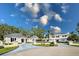 Elegant estate with manicured grounds, a circular driveway, and a classic architectural design at 236 Saint James Park, Osprey, FL 34229