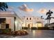 Elegant home with a manicured front yard, a two-car garage, and a stately entrance with blooming flowers at 236 Saint James Park, Osprey, FL 34229