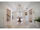 Elegant foyer with marble floors, a grand chandelier, and a view of the staircase at 236 Saint James Park, Osprey, FL 34229