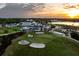 Scenic aerial view of golf course, featuring manicured greens, sand traps, and beautiful landscape with a sunset backdrop at 236 Saint James Park, Osprey, FL 34229