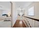 Hallway with hardwood floors, crown molding, and view of bedroom at 236 Saint James Park, Osprey, FL 34229