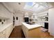 Well-lit kitchen featuring a center island, white cabinets, and modern appliances at 236 Saint James Park, Osprey, FL 34229