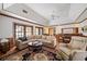 Spacious living room featuring hardwood floors, a fireplace, comfortable seating, and lots of natural light at 236 Saint James Park, Osprey, FL 34229
