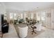 A bright and airy living room with large windows and neutral decor and a plush rug at 236 Saint James Park, Osprey, FL 34229