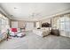Spacious main bedroom with a four-poster bed, sitting area, and large windows with natural light at 236 Saint James Park, Osprey, FL 34229