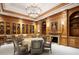 Comfortable meeting room featuring paneled walls, a fireplace, a round table, and ample seating at 236 Saint James Park, Osprey, FL 34229