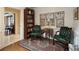 Cozy sitting room featuring comfortable arm chairs, hardwood floors and decor at 236 Saint James Park, Osprey, FL 34229