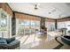 Bright sunroom with tiled floor, golf course views, comfortable seating, and a ceiling fan at 236 Saint James Park, Osprey, FL 34229