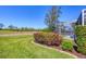 Landscaped backyard with a screened lanai and a view of the open space beyond at 2871 Royal Palm Dr, North Port, FL 34288