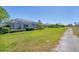 Well-maintained lawn and screened lanai, creating an inviting outdoor living space at 2871 Royal Palm Dr, North Port, FL 34288