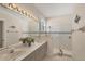 Bright bathroom featuring a double sink vanity, modern lighting, and a glass-enclosed shower at 2871 Royal Palm Dr, North Port, FL 34288