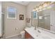 Bathroom with a vanity, toilet, large mirror with modern lights, and shower with glass doors at 2871 Royal Palm Dr, North Port, FL 34288
