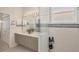 Bathroom with a double sink vanity, ample lighting, and a glass-enclosed shower area at 2871 Royal Palm Dr, North Port, FL 34288