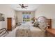 Cozy bedroom featuring a ceiling fan, wooden furniture, and sliding glass doors leading to the pool area at 2871 Royal Palm Dr, North Port, FL 34288