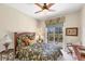 Comfortable bedroom featuring a ceiling fan, natural light, and a door to the backyard at 2871 Royal Palm Dr, North Port, FL 34288